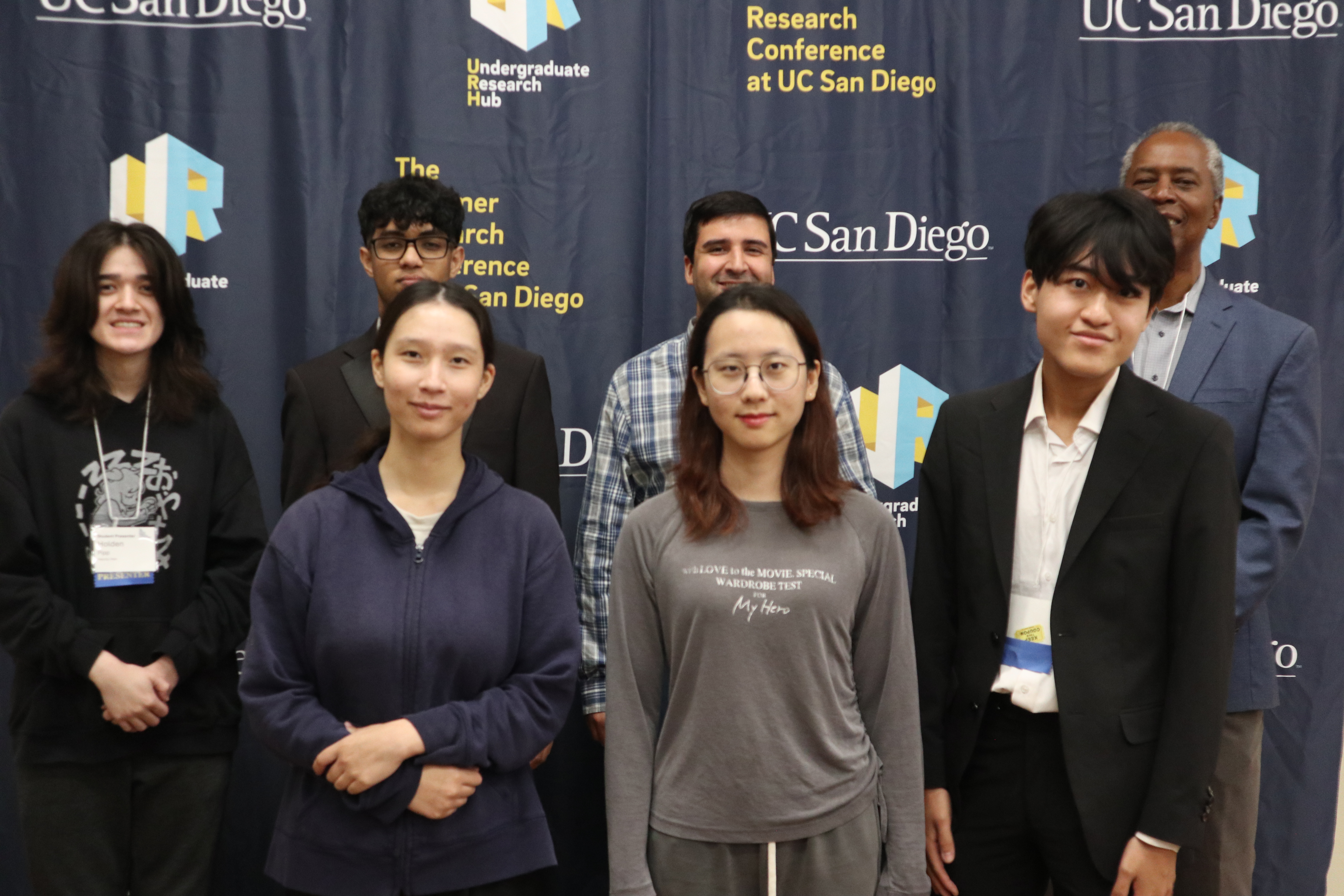 2 administrative directors standing with CAMP scholars at the 2026 summer research conference