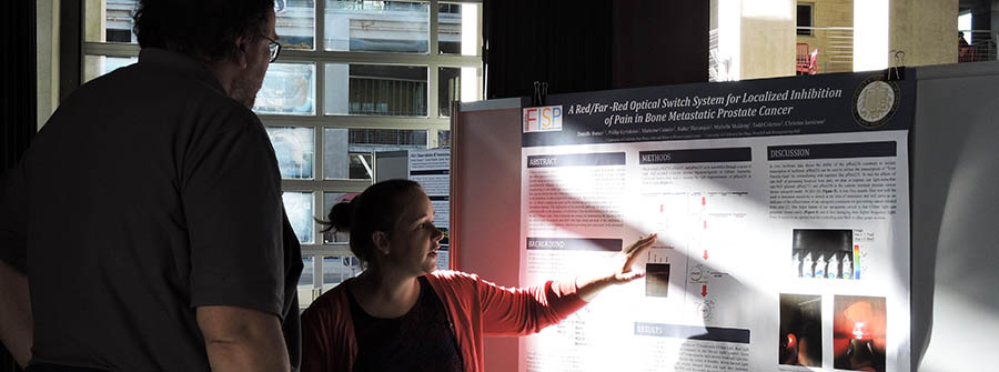3 of 3, A UC San Diego student explains her research project poster-display to an academic mentor at a campus research conference / Academic Enrichment Programs, UC San Diego