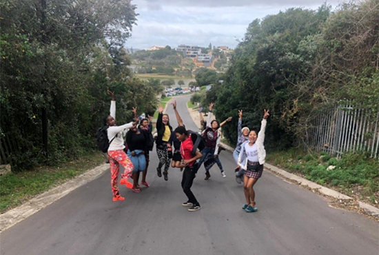 UC San Diego study abroad students frolic on an empty road